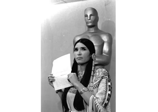 Sacheen Littlefeather, a Native American activist, tells the audience at the Academy Awards ceremony in Los Angeles, March 27, 1973, that Marlon Brando was declining to accept his Oscar as best actor for his role in "The Godfather." Sacheen Littlefeather died Sunday, Oct. 2, 2022, at her home in Marin County, Calif. She was 75. (AP Photo/File)
