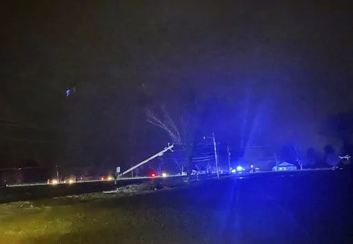 This photo provided by Madison County Sheriff's Office, authorities closed down a road after power lines came down and homes suffered damage early Sunday, Jan. 2, 2022 in Hazel Green, Ala. The storms followed a system earlier Saturday which brought a possible tornado and flooding to parts of Kentucky. (Madison County Sheriff's Office via AP)