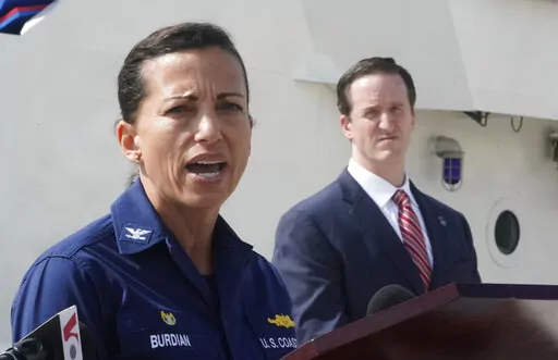U.S. Coast Guard Captain Jo-Ann Burdian, foreground, speaks along with Homeland Security Investigations Special Agent in Charge in Miami Anthony Salisbury, rear, during a news conference, Thursday, Jan. 27, 2022, at Coast Guard Sector Miami in Miami Beach, Fla. The Coast Guard says it has found four more bodies in its search for dozens of migrants lost at sea off Florida, for a total of five bodies. The maritime security agency said Thursday that it also plans to call off its active search for s