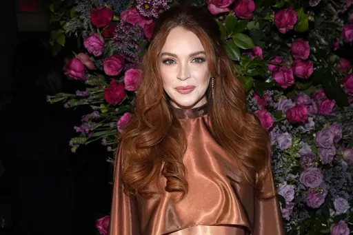 Actress Lindsay Lohan appears at the Christian Siriano Fall/Winter 2023 fashion show in New York, Feb. 9, 2023. The Securities and Exchange Commission said Wednesday, March 22, that Lohan, rapper Akon and several other celebrities have agreed to pay tens of thousands of dollars to settle claims that they promoted crypto investments to their millions of social media followers without disclosing they were being paid to do so. (Photo by Charles Sykes/Invision/AP, File)
