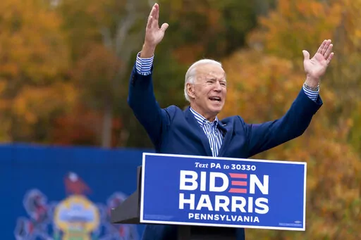 Democratic presidential candidate former Vice President Joe Biden speaks at a drive-in campaign stop at Bucks County Community College in Bristol, Pa., Oct. 24, 2020. Biden and his allies hope big recent wins on climate, health care and more will at least temporarily tamp down questions among top Democrats about whether he will run for reelection. (AP Photo/Andrew Harnik, File)