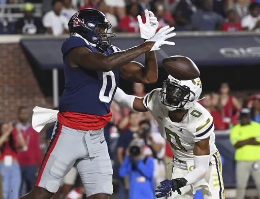 Mississippi tight end Michael Trigg, left, drops a pass under pressure from Georgia Tech defensive back Myles Sims during the first half an NCAA college football game in Oxford, Miss., Saturday, Sept. 16, 2023. (AP Photo/Thomas Graning)