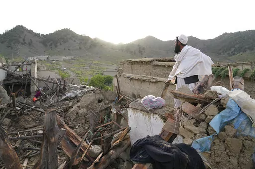 A man stands among destruction after an earthquake in Gayan village, in Paktika province, Afghanistan, Thursday, June 23, 2022. A powerful earthquake struck a rugged, mountainous region of eastern Afghanistan early Wednesday, flattening stone and mud-brick homes in the country's deadliest quake in two decades, the state-run news agency reported. (AP Photo/Ebrahim Nooroozi)