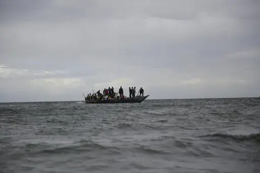 Vendors and fish mongers arrive on an incoming fishing boat at the Gazi Bay with their overnight catch in Kwale county, Kenya on Sunday, June 12, 2022. Countries on Africa's west coast are increasingly turning to climate funding initiatives to innovative financing models to close the large climate financing gaps currently existing in the continent to boost livelihoods of oceanside communities, aid biodiversity recovery responses and enhance take climate action.  (AP Photo/Brian Inganga)