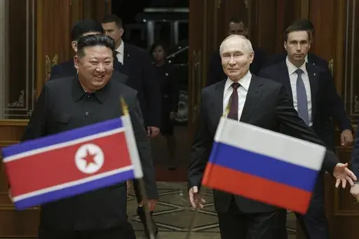 Russian President Vladimir Putin, right, and North Korea's leader Kim Jong Un smile during their meeting at the Pyongyang Sunan International Airport outside Pyongyang, North Korea, on June 19, 2024. (Gavriil Grigorov, Sputnik, Kremlin Pool Photo via AP, File)