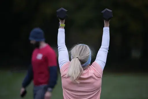 Personal fitness trainer Richard Lamb, leads a group in an outdoor gym class in London, Saturday, Oct. 26, 2024. (AP Photo/Alastair Grant)