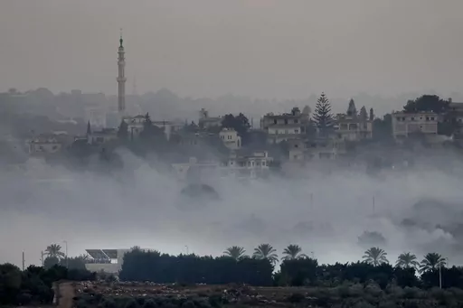 Israeli artillery shelling smoke covers Dahaira, a Lebanese border village with Israel, south Lebanon, Monday, Oct. 16, 2023. Lebanon's militant Hezbollah group says its fighters have targeted an Israeli position along the border directly hitting a Merkava tank. (AP Photo/Hussein Malla)