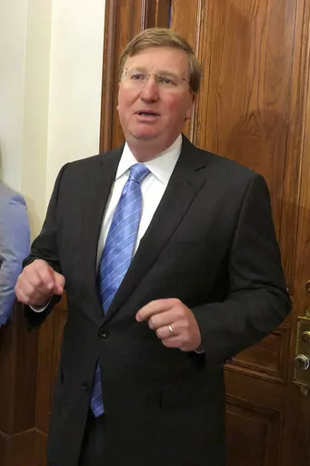 Mississippi Gov. Tate Reeves speaks Thursday, March 24, 2022, during a news conference outside his Capitol office in Jackson, Miss. The Republican says he wants legislators to phase out the state income tax. (AP Photo/Emily Wagster Pettus)