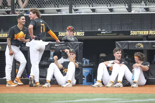 Tennessee players relax during a lightning delay during an NCAA college baseball tournament super regional game against Southern Mississippi in Hattiesburg, Miss., Saturday, June 10, 2023. (James Pugh/impact601.com via AP)