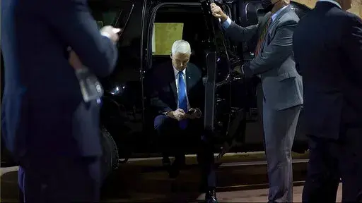 In this image from video released by the House Select Committee, Vice President Mike Pence looks at a phone from his secure evacuation location on Jan. 6 that is displayed as House select committee investigating the Jan. 6 attack on the U.S. Capitol holds a hearing Thursday, June 16, 2022, on Capitol Hill in Washington. (House Select Committee via AP)