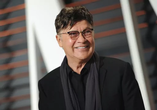 Musician Robbie Robertson arrives at the Vanity Fair Oscar Party on Sunday, Feb. 22, 2015, in Beverly Hills, Calif. Robertson, the lead guitarist and songwriter for The Band, whose classics include “The Weight,” “Up on Cripple Creek” and “The Night They Drove Old Dixie Down,” has died at 80, according to a statement from his manager. (Photo by Evan Agostini/Invision/AP, File)