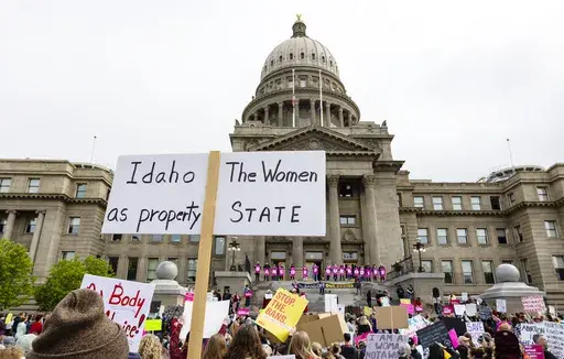 An attendee at Planned Parenthood's Bans Off Our Bodies rally for abortion rights holds a sign reading outside of the Idaho Statehouse in downtown Boise, Idaho, on May 14, 2022. (Sarah A. Miller/Idaho Statesman via AP, File)
