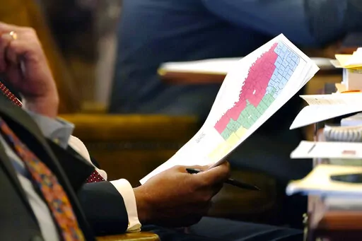 Sen. Joseph Thomas, D-Yazoo City, holds a copy of the proposed congressional redistricting map as debate over a different version is held in the Chamber at the Mississippi State Capitol in Jackson, Miss., Wednesday, Jan. 12, 2022.  Mississippi legislators drew a congressional redistricting plan that diminished Black voters' influence in the state's three majority-white districts, attorneys for the NAACP and two other advocacy groups argue in federal court papers papers. The NAACP, One Voice and 
