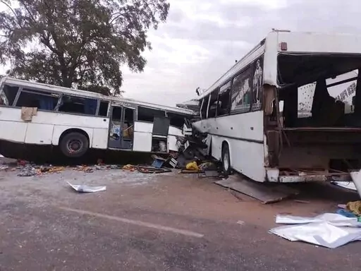 Two damaged buses are pictured after they collided on a road in Gniby, Senegal, Sunday Jan. 8, 2023. At least 40 people were killed and dozens injured in this bus crash in central Senegal, the country's president Macky Sall said Sunday. (Elimane Fall via AP)