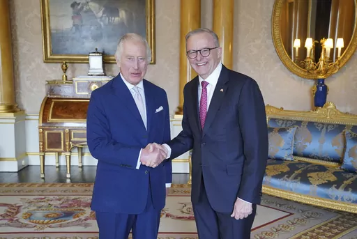 King Charles III, left, receives Australian Prime Minister Anthony Albanese, right, during an audience at Buckingham Palace in London, Britain, Tuesday May 2, 2023. (Jonathan Brady/Pool via AP)