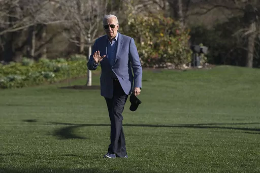 President Joe Biden waves to members of the media as he walks across the South Lawn of the White House after exiting the Marine One helicopter, Sunday, March 24, 2024, on return to Washington from Delaware. (AP Photo/Jacquelyn Martin)