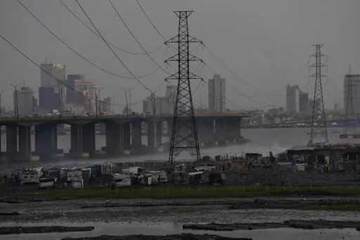 High tension power lines pass through Makoko slum in Lagos, Nigeria, Saturday, Aug. 20, 2022. From Zimbabwe, where many must work at night because i t's the only time there is power, to Nigeria where collapses of the grid are frequent, the reliable supply of electricity remains elusive across Africa. (AP Photo/Sunday Alamba/File)