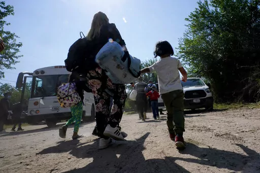 A migrant family from Venezuela walks to a Border Patrol transport vehicle after they and other migrants crossed the U.S.-Mexico border and turned themselves in June 16, 2021, in Del Rio, Texas. The Biden administration has agreed to accept up to 24,000 Venezuelan migrants, similar to how Ukrainians have been admitted after Russia’s invasion, while Mexico has agreed to accept some Venezuelans who are expelled from the United States, the two nations said Wednesday, Oct. 12, 2022. (AP Photo/Eric