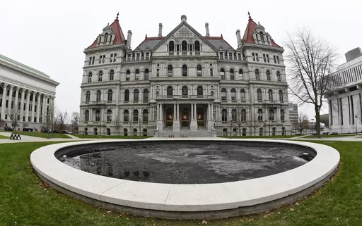 The New York state Capitol in Albany, N.Y., is pictured on Dec. 14, 2020. New York's minimum-wage workers had more than just the new year to celebrate Monday, Jan. 1, 2024, with a pay bump kicking in as the clock ticked over to 2024. In the first of a series of annual increases slated for the Empire State, the minimum wage increased to $16 in New York City and some of its suburbs, up from $15. In the rest of the state, the new minimum wage is $15, up from $14.20. (AP Photo/Hans Pennink, File)