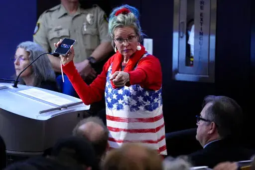 A woman points at Maricopa County Recorder Stephen Richer during the Maricopa County Board of Supervisors general election canvass meeting, Monday, Nov. 28, 2022, in Phoenix. (AP Photo/Matt York)