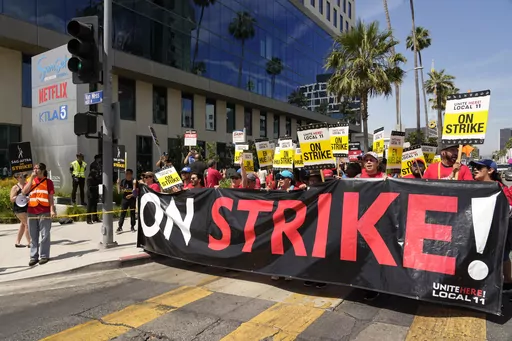 Striking Hotel workers from Unite Here Local 11 join the picketing actors of SAG-AFTRA, and writers of the WGA, outside Netflix studios, July 21, 2023, in Los Angeles. On Saturday, Sept. 30, California Democratic Gov. Gavin Newsom vetoed a bill that would have made some striking workers eligible for unemployment benefits. (AP Photo/Chris Pizzello, File)