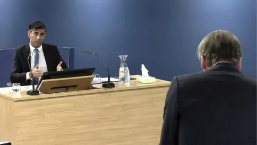 This screen grab from the UK COVID-19 Inquiry live stream shows Britain's Prime Minister Rishi Sunak giving evidence at Dorland House, in London, Monday, Dec. 11, 2023. Sunak faces one of the toughest weeks of his 13 months in office. On Monday he will be grilled by lawyers about his decisions during the COVID-19 pandemic while fending off a rebellion from lawmakers over his signature immigration policy. (UK COVID-19 Inquiry/PA via AP)