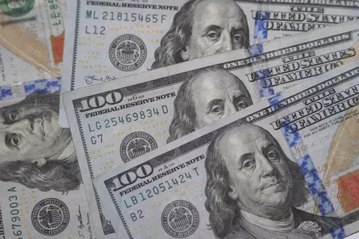 This Jan. 22, 2020, file photo shows the likeness of Benjamin Franklin on $100 bills in Dallas. Realizing that financial stress is common can be the first step toward reducing it, money experts say. Thinking you are the only one experiencing it can compound those negative feelings. Checking in with your body, so you notice when you’re having a fight-or-flight response to financial decisions, can also help. (AP Photo/LM Otero, File)