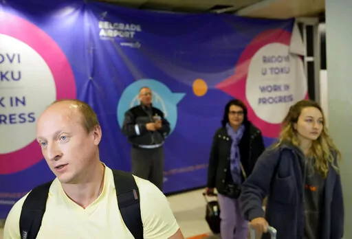 Vladimir, a passenger from the Moscow-Belgrade flight operated by Air Serbia, speaks to the media at the airport in Belgrade, Serbia, Wednesday, Sept. 21, 2022. Large numbers of Russians rushed to book one-way tickets out of the country while they still could after Russian President Vladimir Putin announced a partial mobilization of military reservists for the war in Ukraine. (AP Photo/Darko Vojinovic)