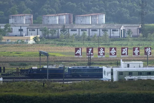 A green train with yellow trimmings, resembling one used by North Korean leader Kim Jong Un on his previous travels, is seen steaming by a slogan which reads "Towards a new victory" on the North Korea border with Russia and China seen from China's Yiyanwang Three Kingdoms viewing platform in Fangchuan in northeastern China's Jilin province on Monday, Sept. 11, 2023. Russia and North Korea confirmed Monday that North Korean leader Kim Jong Un will visit Russia in a highly anticipated meeting with