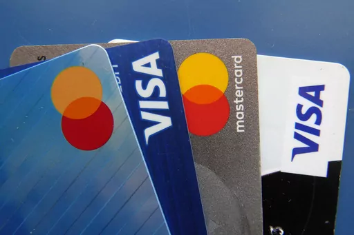 Credit cards as seen July 1, 2021, in Orlando, Fla. Many Americans say their household expenses are outpacing earnings in 2023 according to a new poll from AP-NORC Center for Public Affairs Research. (AP Photo/John Raoux, File)