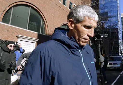 William "Rick" Singer founder of the Edge College & Career Network, departs federal court in Boston, on March 12, 2019. The mastermind of the nationwide college admissions bribery scandal is set to be sentenced on Wednesday, Jan. 4, 2023, after helping authorities secure the convictions of a slew of wealthy parents involved in his scheme to rig the selection process at top-tier schools. (AP Photo/Steven Senne, File)