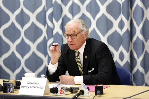 South Carolina Gov. Henry McMaster looks at data about the COVID-19 spread in the Kershaw County School District during a discussion with school officials at Camden Elementary School on Wednesday Sept. 15, 2021, in Camden, S.C. McMaster has quietly signed into law a bill, Monday, May 16, that would ban transgender students from playing girls’ or women’s sports in public schools and colleges as the state joins about a dozen others that have passed similar laws in the past two years . (AP Phot