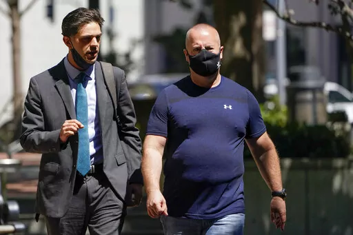 James Theodore Highhouse, right, arrives for his sentencing hearing at U.S. District Court with his attorney Jaime Dorenbaum, left, in Oakland, Calif., Wednesday, Aug. 31, 2022. Highhouse pleaded guilty to sexually abusing an inmate while working as a prison chaplain at a federal women's prison in Dublin, Calif. (AP Photo/Godofredo A. Vásquez)