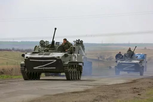Russian military vehicles move on a highway in an area controlled by Russian-backed separatist forces near Mariupol, Ukraine, April 18, 2022. Mariupol, a strategic port on the Sea of Azov, has been besieged by Russian troops and separatist forces in eastern Ukraine for more than six weeks. (AP Photo/Alexei Alexandrov, File)