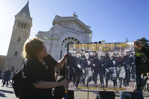 People march in the hometown of former dictator Benito Mussolini to mark the 100th anniversary of the coup d'etat by which he sized power in 1922, in Predappio, Italy, Sunday, Oct. 30, 2022. (AP Photo/Luca Bruno)