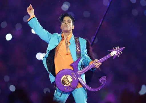 In this Feb. 4, 2007, file photo, Prince performs during the halftime show at the Super Bowl XLI football game in Miami. The six-year legal battle over pop superstar Prince’s estate has ended, meaning the process of distributing the artist's wealth could begin in February 2022. (AP Photo/Chris O'Meara, File)