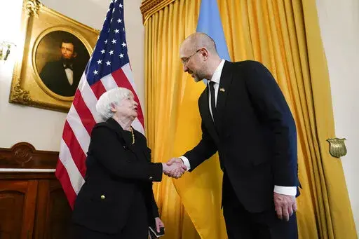 Treasury Secretary Janet Yellen, left, shakes hands with Prime Minister of Ukraine Denys Shmyhal, right, before their meeting at the Treasury Department in Washington, Thursday, April 21, 2022. (AP Photo/Susan Walsh)