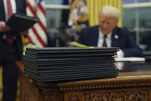 President Donald Trump signs executive orders in the Oval Office of the White House, Jan. 20, 2025, in Washington. (AP Photo/Evan Vucci, File)