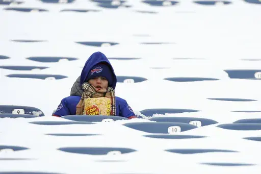 In this photo from last January, a Buffalo Bills fan sits amongst snow covered seats while waiting for the start an NFL wild-card playoff football game between the Buffalo Bills and the Pittsburgh Steelers, Jan. 15, 2024, in Buffalo, N.Y. (AP Photo/Jeffrey T. Barnes, File)