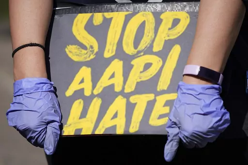 A person holds a sign and attends a rally to support stop AAPI (Asian Americans and Pacific Islanders) hate at the Logan Square Monument in Chicago, on March 20, 2021. Despite ongoing efforts to combat anti-Asian racism that arose after the pandemic, a third of Asian Americans and Pacific Islanders say they have experienced an act of abuse based on their race or ethnicity in the last year. (AP Photo/Nam Y. Huh, File)