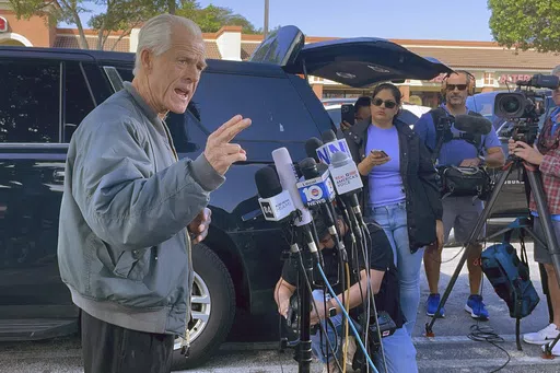 Former Trump White House official Peter Navarro speaks to reporters before he heads to prison, Tuesday, March 19, 2024 in Miami, to begin serving his sentence for refusing to cooperate with a congressional investigation into the Jan. 6, 2021, attack on the U.S. Capitol. (AP Photos/Adriana Gomez Licon)