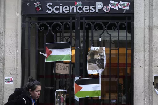A student walks past th entrance of Sciences-Po university in Paris Friday, April 26, 2024. Students in Paris inspired by Gaza solidarity encampments at campuses in the United States blocked access to a campus building at a prestigious French university Friday, prompting administrators to move all classes online. The pro-Palestinian protest at the Paris Institute of Political Studies, known as Sciences Po, came two days after police broke up a separate demonstration at one of the university's am