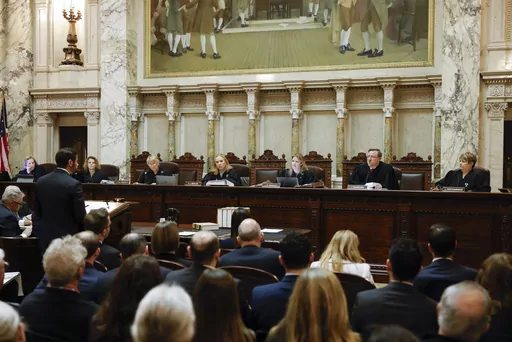 The Wisconsin Supreme Court listens to arguments from Wisconsin Assistant Attorney General Anthony D. Russomanno, representing Gov. Tony Evers, during a redistricting hearing at the state Capitol, Nov. 21, 2023, in Madison, Wis. The liberal-controlled Wisconsin Supreme Court overturned Republican-drawn legislative maps on Friday, Dec. 22, and ordered that new district boundary lines be drawn as Democrats had urged in a redistricting case they hope will weaken GOP majorities. (Ruthie Hauge/The Ca