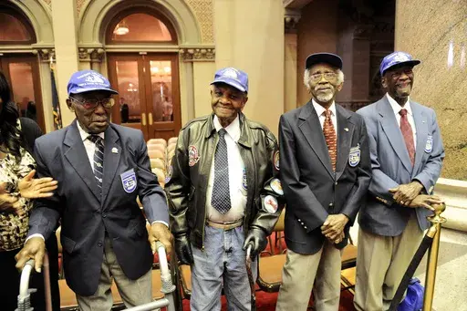 Tuskegee Airmen, from left, Audley Coulthurst of New York, William Johnson of Glen Cove, N.Y., Wilfred R. DeFour of New York, and Herbert C. Thorpe of Rome, N.Y., are honored by members of the New York Assembly upon their 75th Anniversary of the 332nd Fighter Group of the U.S. Army Air Corps during a recognition ceremony in the Assembly Chamber at the state Capitol, June 16, 2016, in Albany, N.Y. (AP Photo/Hans Pennink, File)
