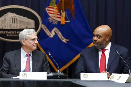 Attorney General Merrick Garland, looks at federal prosecutor Kevin Chambers, right, after appointing him to be the Justice Department's chief pandemic fraud prosecutor, during a meeting of the coronavirus disease (COVID-19) Fraud Enforcement Task Force at the Justice Department, March 10, 2022 in Washington. The U.S. Secret Service recovered $286 million in fraudulently obtained pandemic funds to the Small Business Administration, Friday, Aug. 26. (Kevin Lamarque/Pool Photo via AP, File)