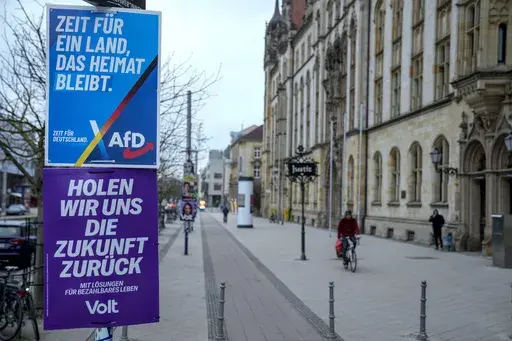An election poster of the far-right anti-immigrant party Alternative For Germany party AfD, with with the slogan reading "It's time for a country that is still a home country", is displayed in a street, in Magdeburg, Germany, Friday, Feb. 7, 2025. (AP Photo/Ebrahim Noroozi)