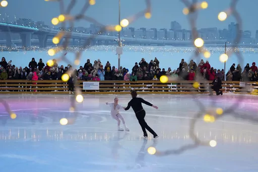 People watch figure skaters perform on the opening day of the largest skating rink in St. Petersburg with an area of 11,400 square meters, in St. Petersburg, Russia, Sunday, Dec. 3, 2023. (AP Photo/Dmitri Lovetsky)