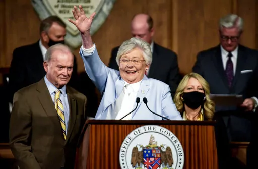 Alabama Gov. Kay Ivey waves as she arrives to deliver her State of the State address at the State Capitol Building in Montgomery, Ala., Jan. 11, 2022. Two families with transgender teens and two physicians have sued the state of Alabama to block a law that makes it a crime for doctors to treat trans youth under 19 with puberty blockers or hormones to help affirm their gender identity. The suit was filed Monday, April 11, 2022 in federal court. (Mickey Welsh/The Montgomery Advertiser via AP, File