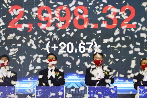 Yoon Suk Yeol, center right, the presidential election candidate of South Korea's main opposition People Power Party (PPP), and Lee Jae-myung, center left, the presidential election candidate of the ruling Democratic Party, attend a ceremony for the first trading day of stock market at the Korea Exchange (KRX) in Seoul, South Korea Monday, Jan. 3, 2022. (Kim Hong-ji/Pool Photo via AP)