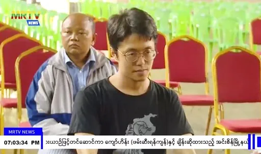 In this image taken from video by Myanmar state broadcaster MRTV, Japanese national Toru Kubota is shown seated during a ceremony inside the Insein prison in Yangon, Myanmar on Thursday, Nov. 17, 2022. Myanmar’s military-controlled government says it is releasing and deporting an Australian academic, a Japanese filmmaker, an ex-British diplomat and an American as part of a broad prisoner amnesty marking the country’s National Victory Day. (MRTV via AP)